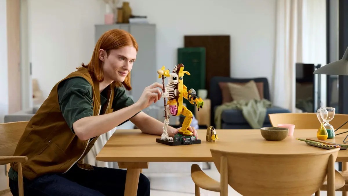 A man sitting at a table with a toy