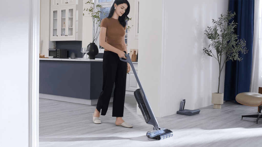 A woman using a vacuum cleaner