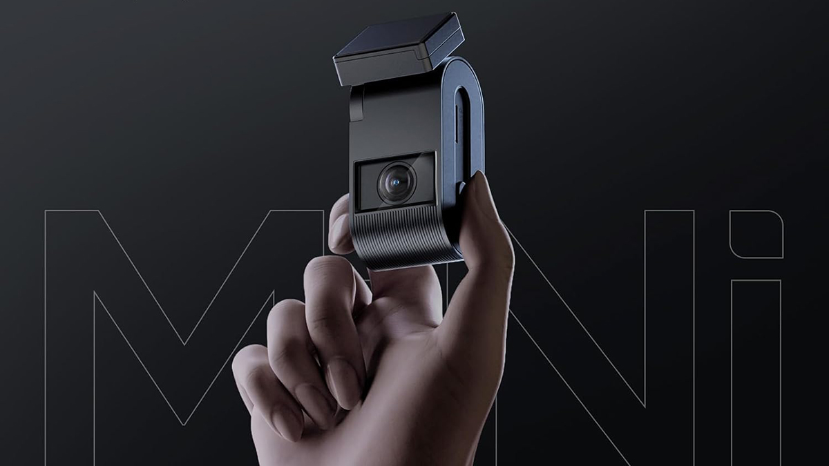 A hand holding a camera