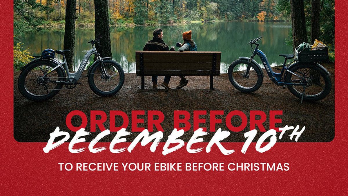 A man and woman sitting on a bench next to a lake