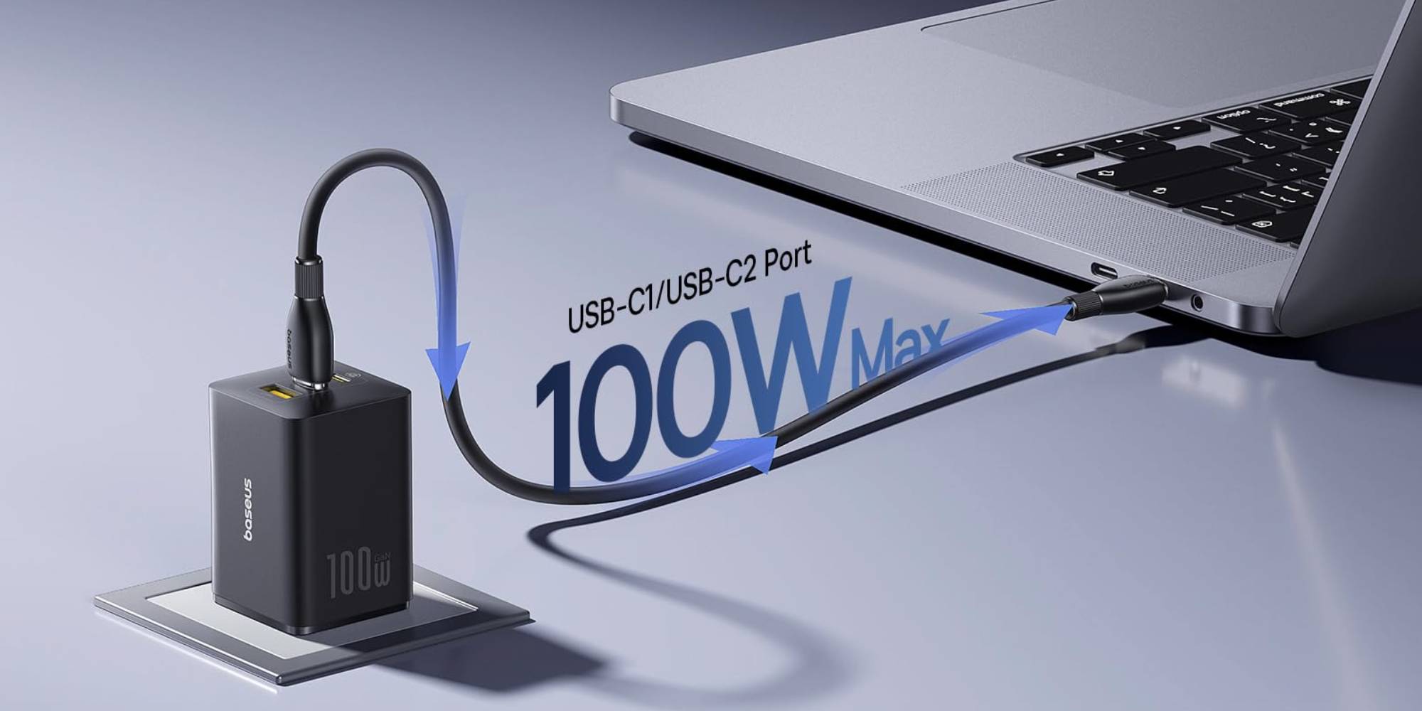 A computer with a black box connected to a black cord