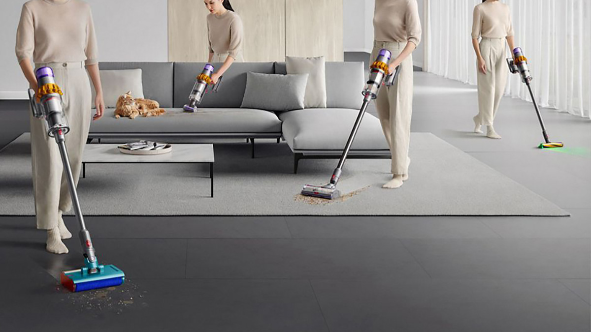 A woman vacuuming a couch