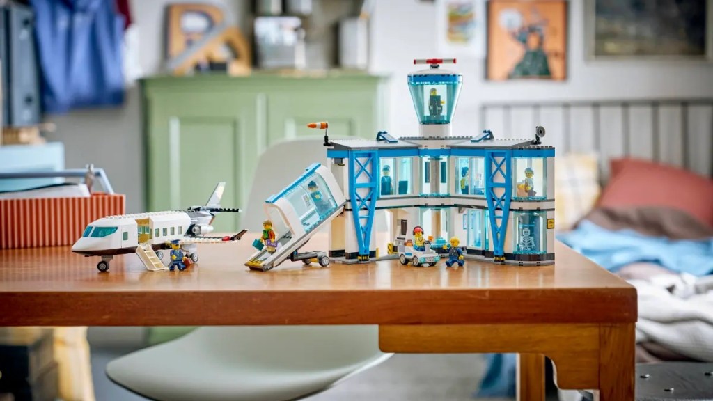 A toy airplane and building on a table