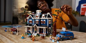 A woman playing with a toy house