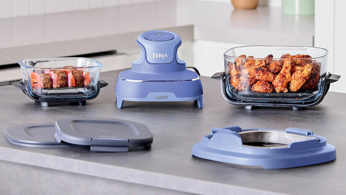 A blue food processor with chicken wings in it