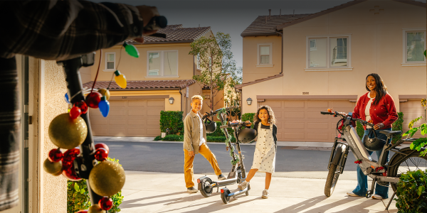 A boy and girl standing next to a scooter