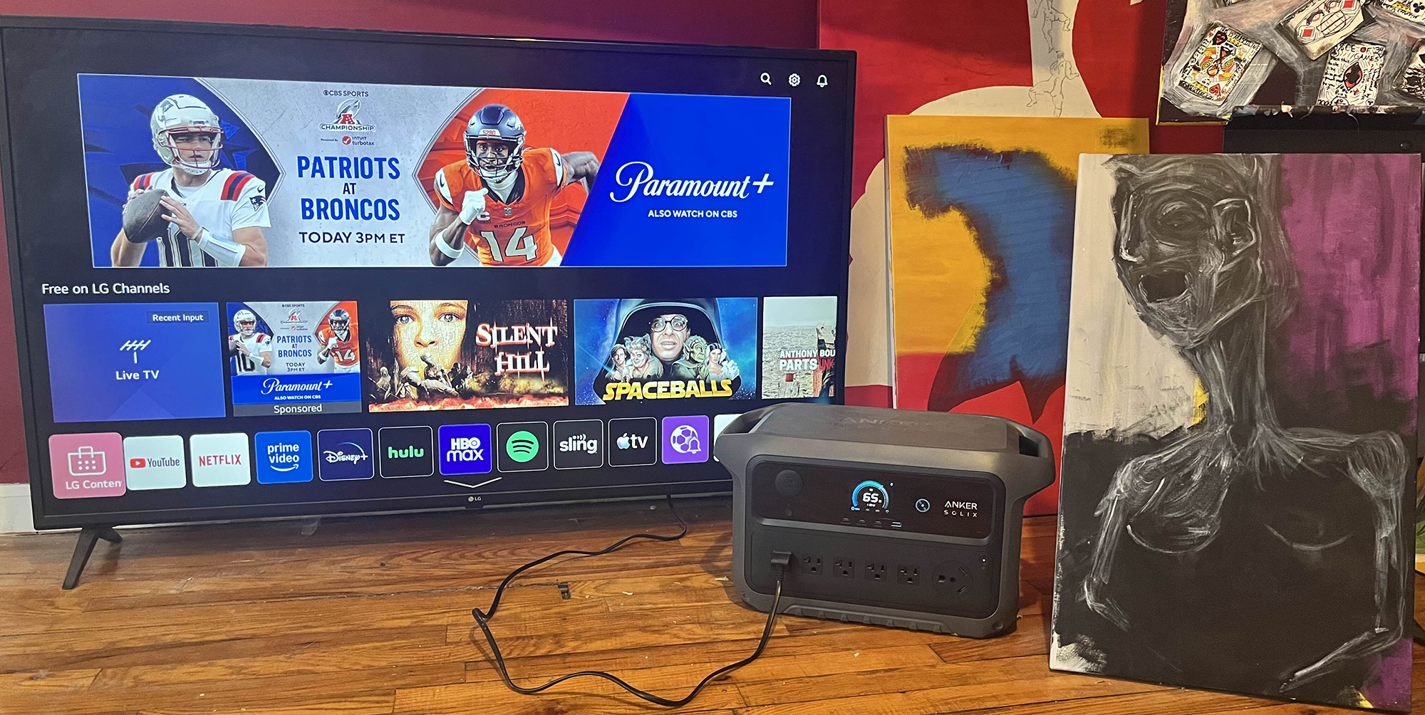 A television and a box on a wood floor