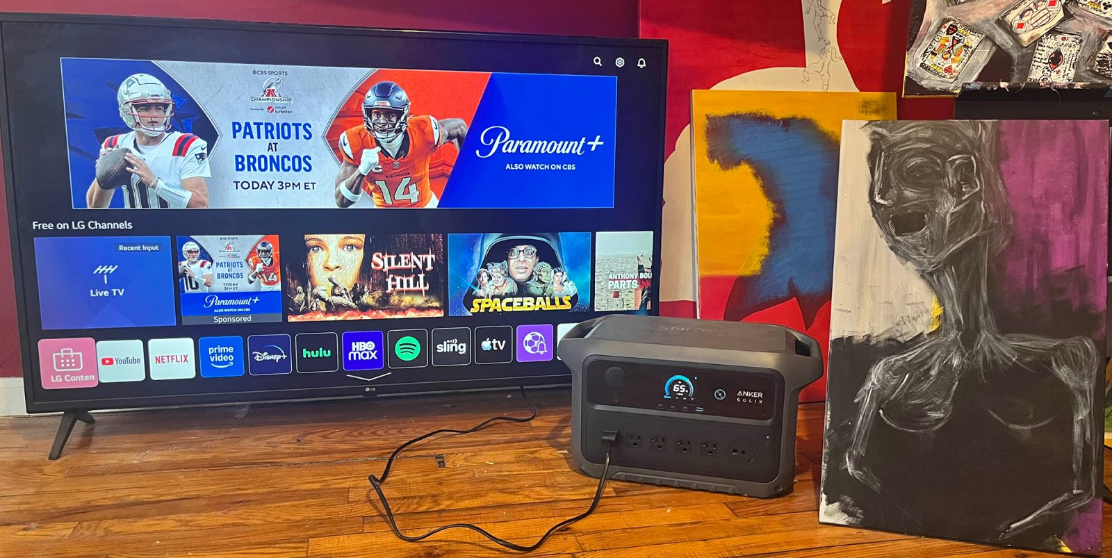 A television and a box on a wood floor