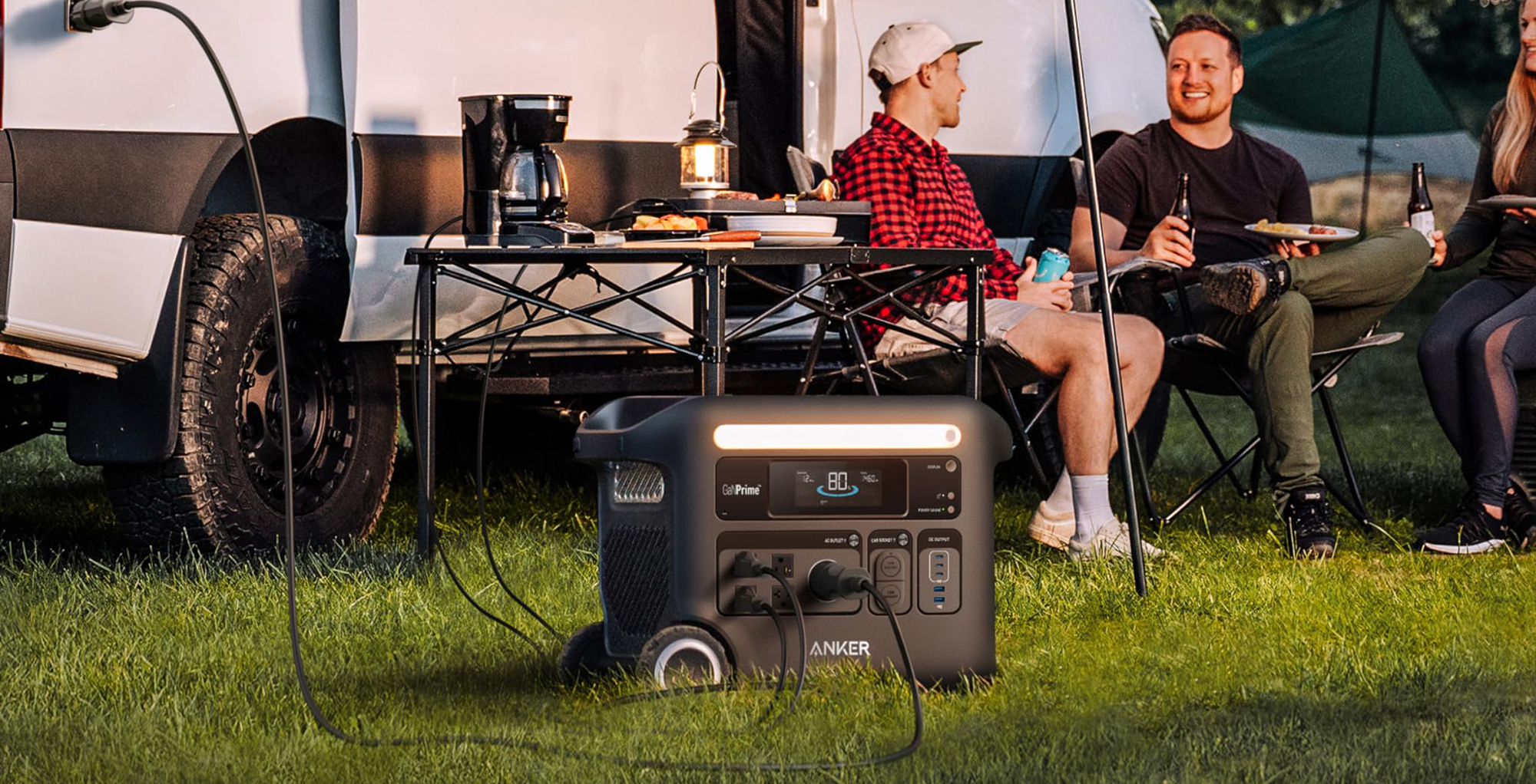 A group of people sitting outside on grass
