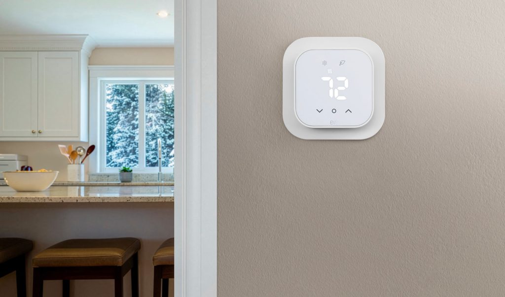 A digital thermostat on a wall