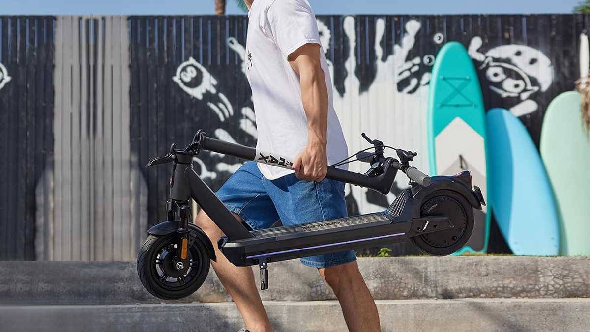 A man holding a scooter
