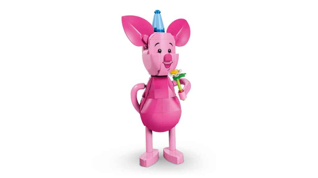 A pink toy animal holding a flower