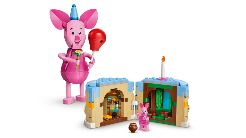 A toy pig with a balloon and a building block