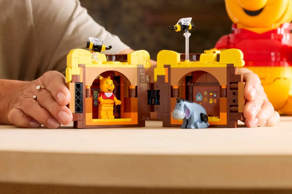A person holding a LEGO Winnie the Pooh