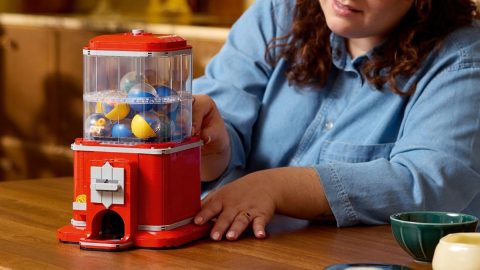 A woman playing with a toy machine