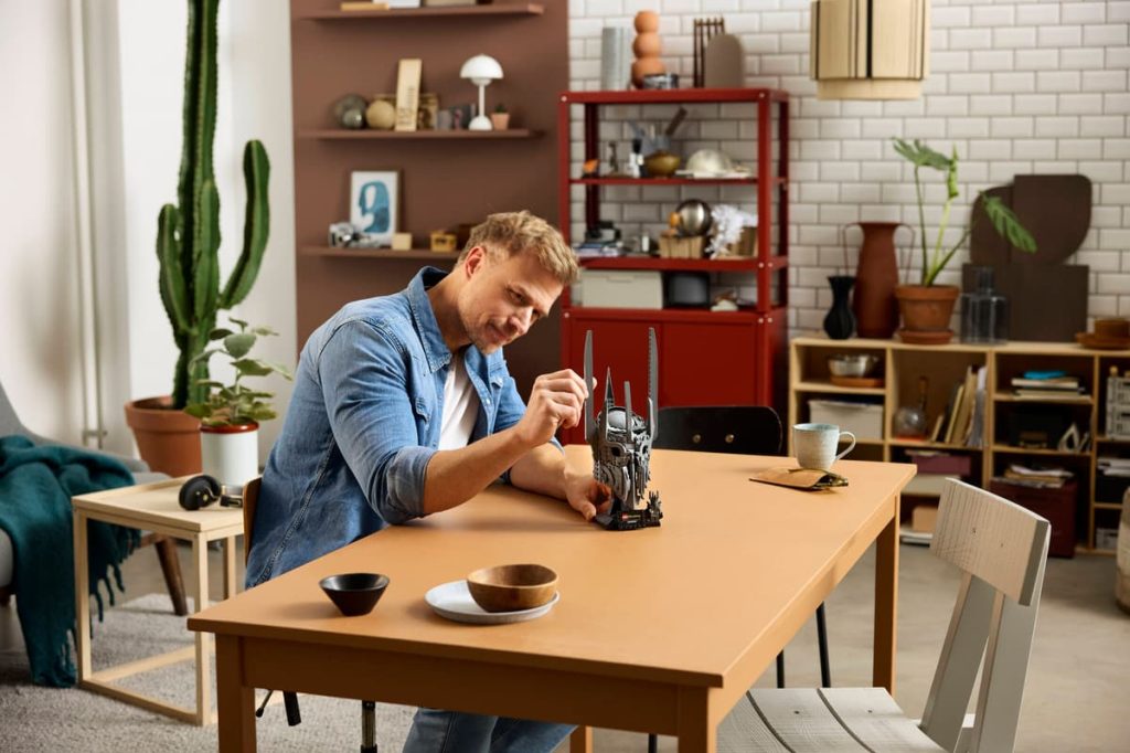 A man sitting at a table with a toy