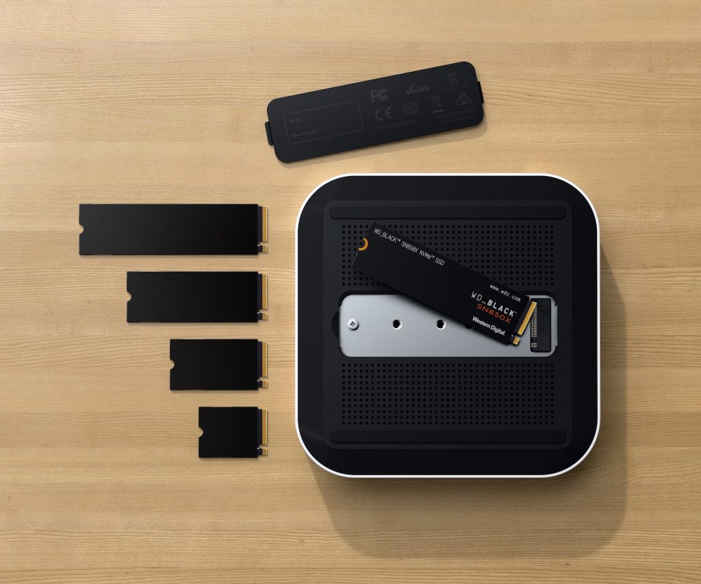 A black rectangular object with rectangular objects on a wooden surface