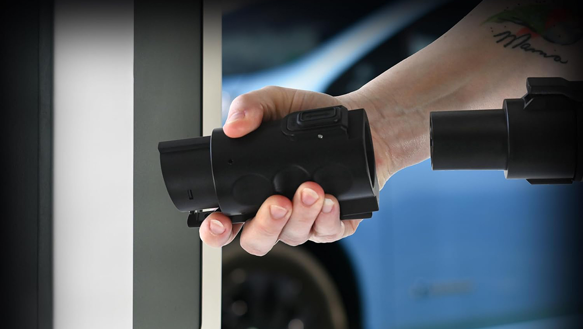 A hand holding a black object