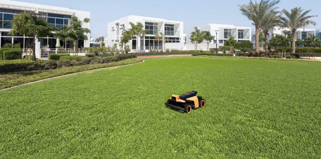 A toy lawnmower in a grassy area