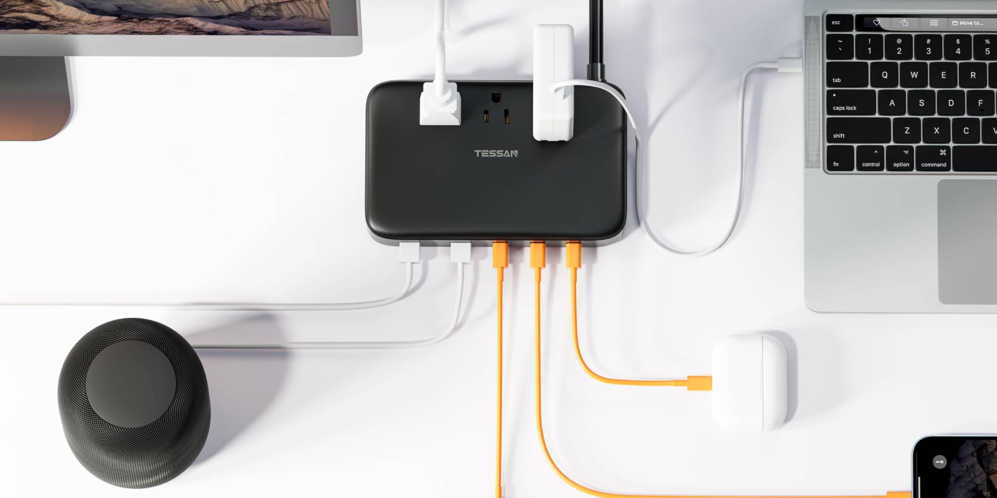 A black rectangular device with white and orange cables connected to it