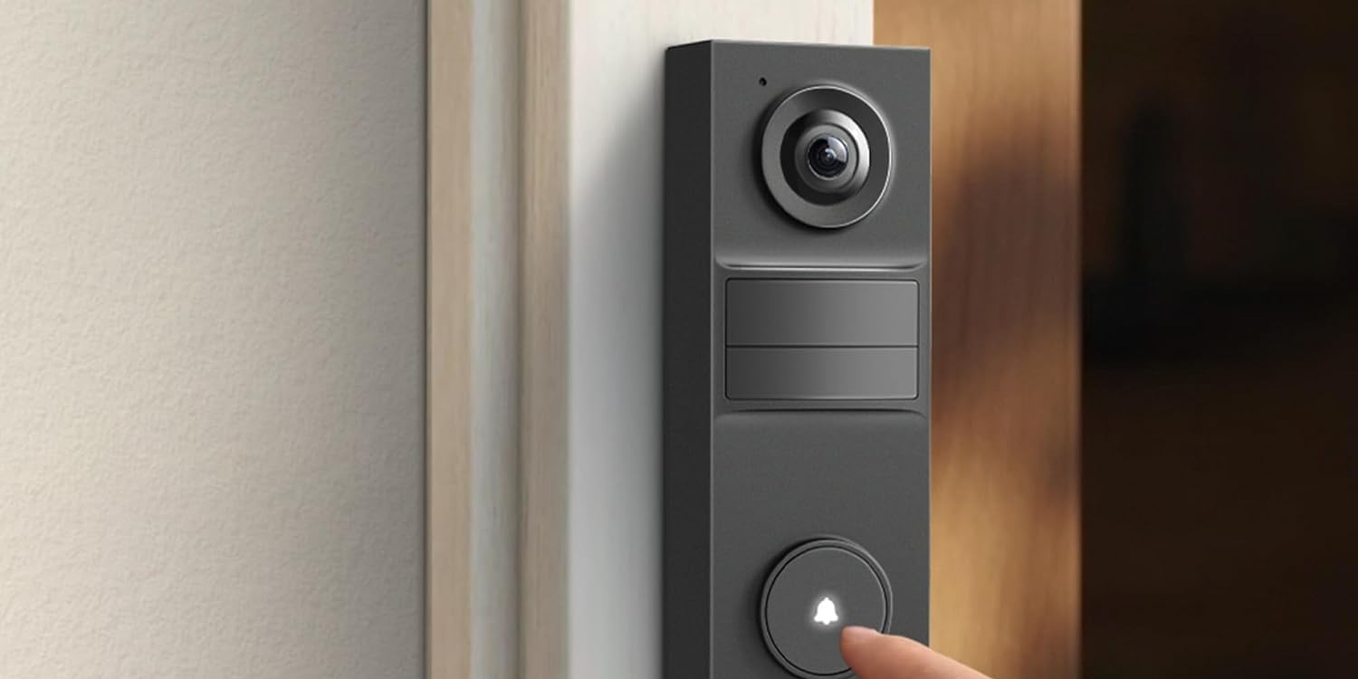 A finger pressing a button on a door bell