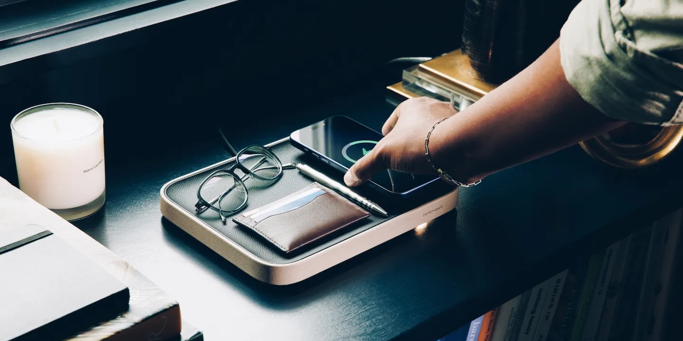 A hand touching a phone on a device