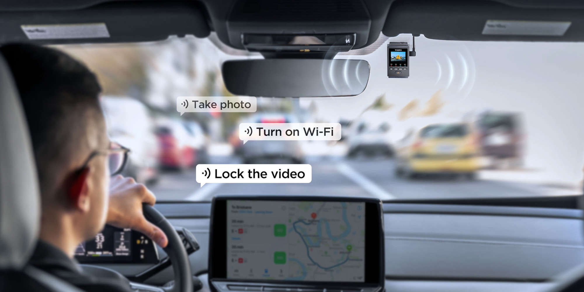 A car with a steering wheel and a hand holding a steering wheel