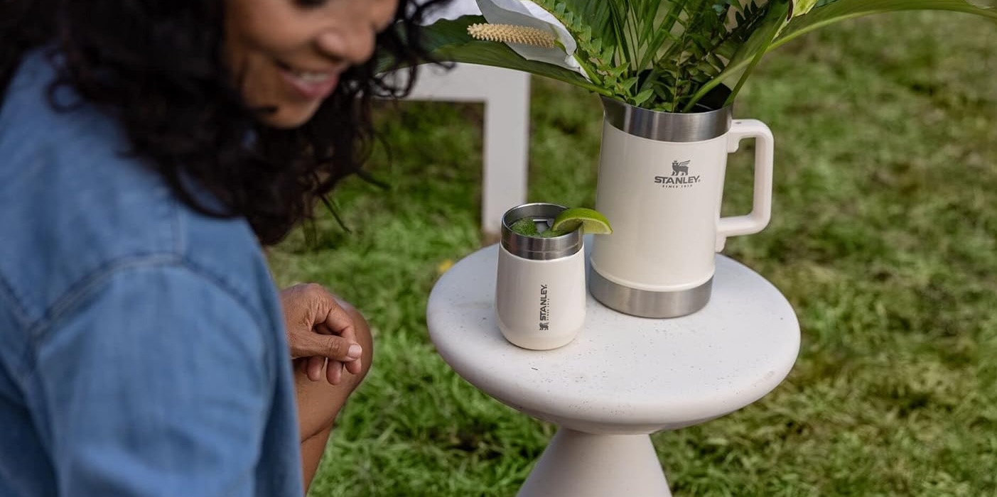 A woman looking at a drink on a table