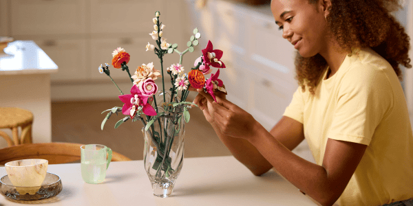 A woman holding flowers in a vase